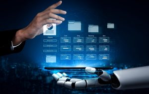  A human hand and a robotic hand hold a glowing tablet displaying digital folders and data charts