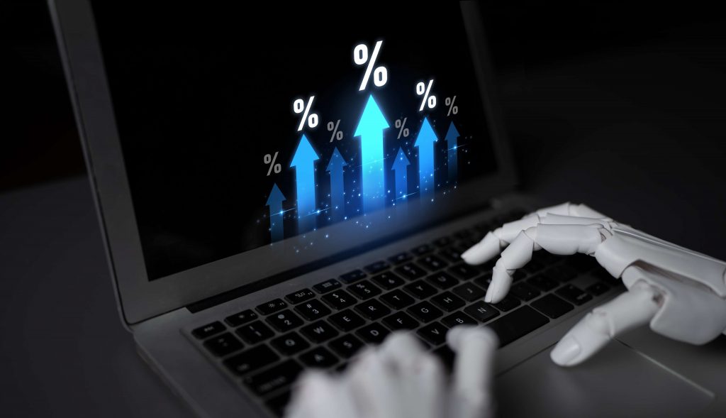A robotic hand types on a laptop showing upward blue arrows and percentage symbols